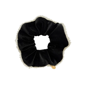 Elegant black velvet scrunchie with white pearl trim and a golden metal charm