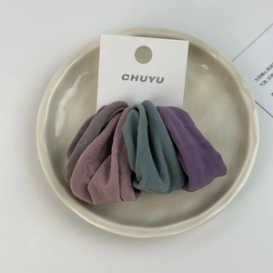 Detailed view of three Morandi color fabric scrunchies on white display card