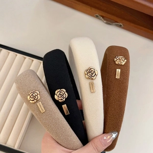 Retro Camellia sponge headband in khaki, black, white, and brown with gold metal details