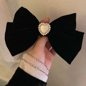 Large black velvet bow hair clip with a pearl-lined heart centerpiece in French retro style