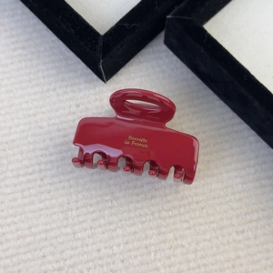 Detail shot of the wine red acetate hair claw featuring golden Barrette La France lettering