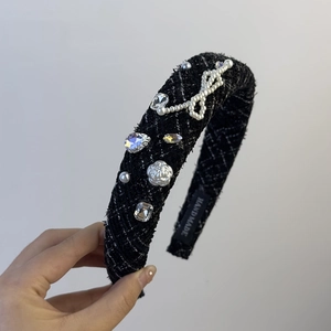 Detail of tweed headband with pearl bow, rhinestones and floral charm, handmade finish