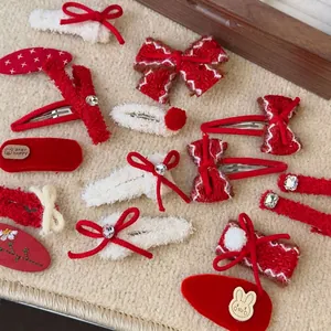 Festive red and white bow hair clip set with plush faux fur and knitted rhinestone details