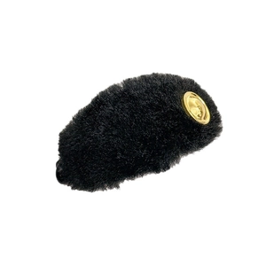 Elegant large black plush hair clip for women with golden metal buckle detail on white backdrop