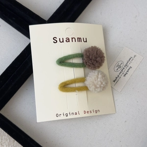 Set of two colorful wool felt pompom snap hair clips for girls on display card