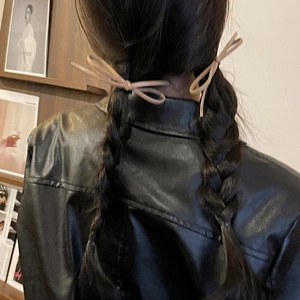 Minimalist beige bow hair ties on braided pigtails for versatile ponytail styling