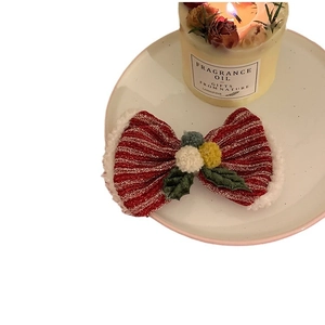 Cute red Christmas bow headband with white plush trim and festive holiday pom-poms