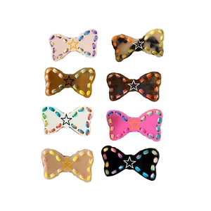 Set of 8 colorful resin bow hair clips with star patterns and contrast stitching detail