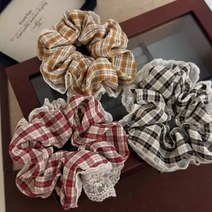 Set of three French vintage plaid scrunchies with lace trim in red, brown, and monochrome