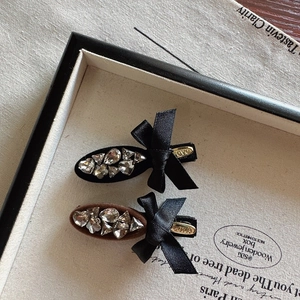 Elegant bow hair clips with shimmering crystals and silk ribbon in black and brown colors