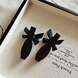 Set of two elegant black satin bow hair clips with silver metal duckbill base