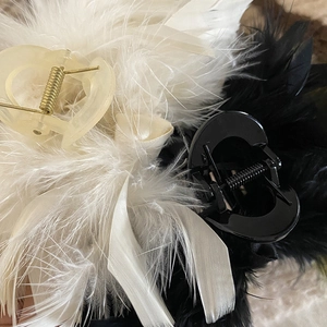 Elegant ostrich feather hair claw clips in black and creamy white with satin ribbons