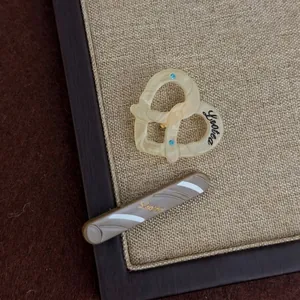 Acetate hair clip set with cream heart claw and brown striped barrette featuring blue rhinestones