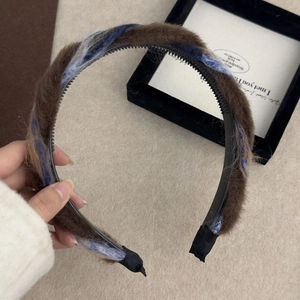 Gros plan sur un serre-tête tressé en peluche avec dents antidérapantes et texture bleu marron