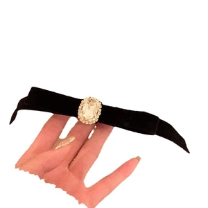 Elegant black velvet bow hair clip featuring a large rectangular crystal rhinestone center
