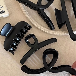 Matte black large hair claw clips set in four minimalist shapes for elegant updos
