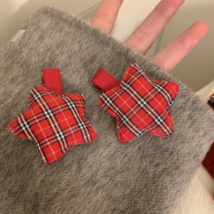 Pair of festive red tartan star-shaped hair clips with padded 3D design for women