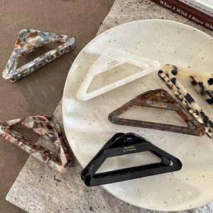 Set of minimalist triangular acetate hair claws in various elegant marble and tortoiseshell patterns