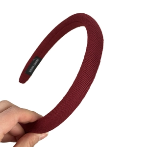 Classic red ribbed knit headband with gold label for a festive French vintage autumn look