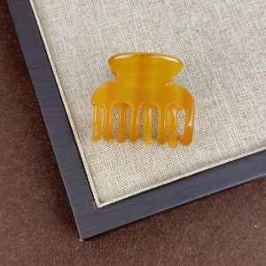 Amber acetate hair claw clip with long teeth and French style design for elegant updos