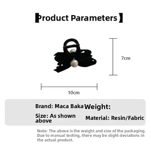 Detail view of black velvet bow hair claw with pearl showing 10cm by 7cm dimensions