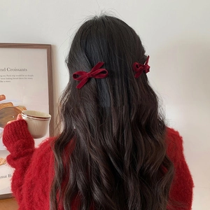Pair of elegant wine red velvet bow hair clips for women with luxurious texture