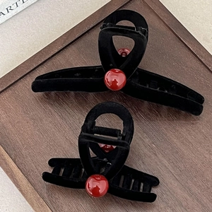 Elegant black velvet shark clips with red pearl accents in large and medium sizes