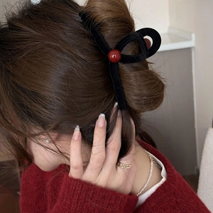 Elegant black velvet claw clip with a red pearl accent for sophisticated hairstyles
