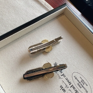 Elegant bow hair clips with pearls and rhinestones on a vintage golden metal duckbill base
