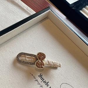 Elegant bow-shaped hair clip with sparkling rhinestones and beige twill fabric wrap