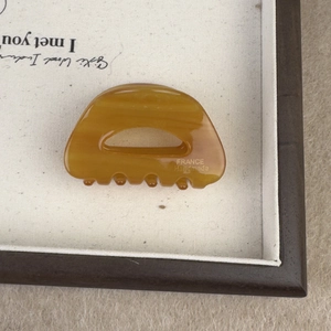 Close-up of tortoise shell pattern acetate hair claw clip with France Handmade engraving