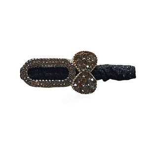 Elegant rhinestone bow hair clip with black fabric base for a vintage sophisticated style