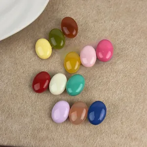 Detailed view of colorful candy-colored oval bead hair clips on a soft beige felt surface