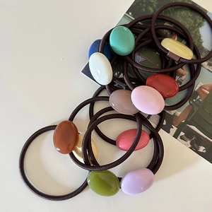 Close-up of colorful resin hair ties with elastic bands in various candy colors