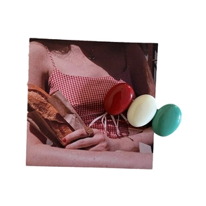 Three colorful oval hair clips in red, cream, and green with a glossy glaze finish