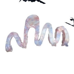 Elegant wavy acetic acid hair claw clip with pink and blue marble pattern on white background