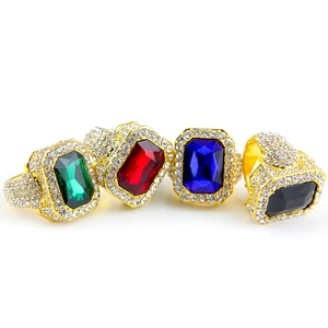 Detailed macro view of square gemstone rings with crystal pavé in gold finish