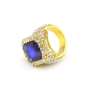 Macro detail of men's gold hip hop ring with large blue square stone and pavé zircons