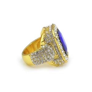 Detail view of large oval blue gemstone set in a gold plated hip-hop ring with pavé crystals