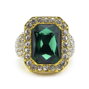 Close-up of gold-plated square ring with emerald-cut green gemstone and cubic zirconia pavé