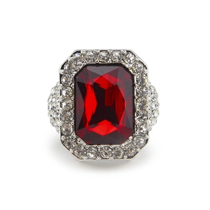 Macro shot of silver ring with large red rectangular stone and pave-set crystals