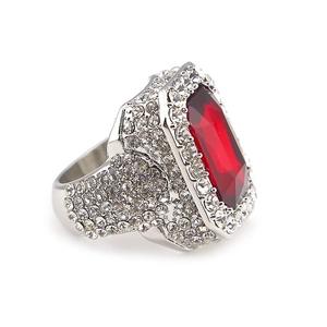 Macro shot of silver alloy hip hop ring with red rectangular stone and micro pave diamonds