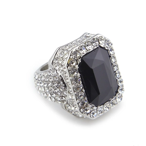 Macro shot of silver hip hop ring featuring a large black rectangular gem and pavé rhinestones