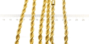 Detailed macro view of 6mm golden rope chains with a ruler showing thickness and scale