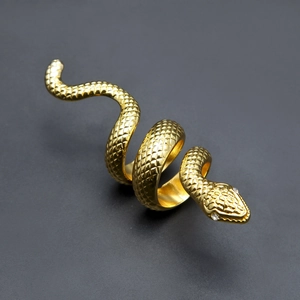 Macro detail of golden snake ring showing fine scale texture and sparkling zircon eyes