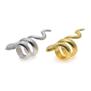 Close-up of punk style snake rings in gold and silver with sparkling rhinestone eyes