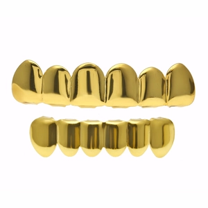 Detailed close-up of polished gold-plated hip-hop grillz set with mirror finish and 12 teeth