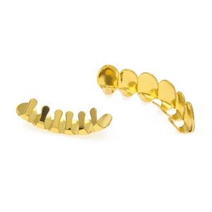 Close-up of polished gold-plated hip hop grillz set showing top and bottom teeth rows