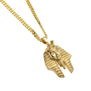 Detailed close-up of hip hop Pharaoh pendant with crystal eyes on a gold Cuban chain