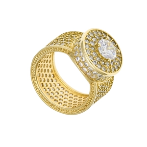 Detailed macro view of gold hip hop ring featuring a large round center stone and pavé setting